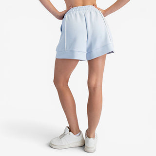 Blue scuba knit A-line shorts with contrast piping and relaxed fit shown back view
