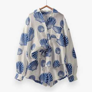Seashell print gauze short set on hanger showing button down top and drawstring shorts in lightweight textured fabric