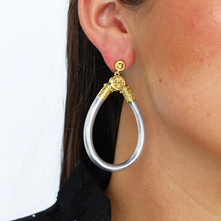 BudhaGirl Silver All Weather Earrings worn on model, silver teardrop statement earrings with gold-tone details, lifestyle view showing scale and fit on ear