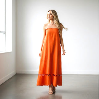 Orange strapless maxi dress with scallop trim detail and flowy resort silhouette front view