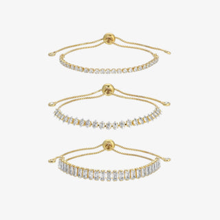 Three gold bracelets with diamond accents on a white background