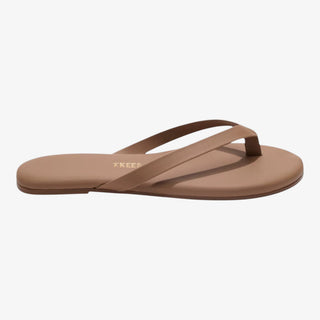 tan leather flip flop sandal on foot casual outfit styling side view