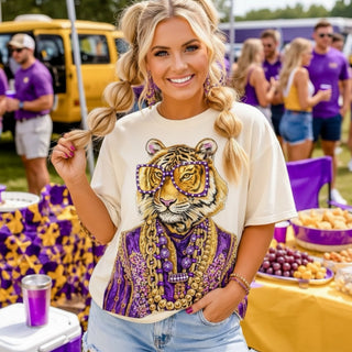 Cream tiger rhinestone tee with purple sunglasses and gold jewelry styled with denim shorts for LSU game day tailgate party. 