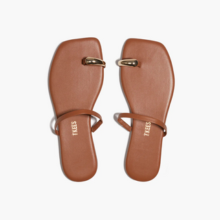 Pair of brown sandals with gold straps on a white background