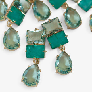 Turquoise ombre crystal drop earrings with rectangular green stones and aqua teardrop pendants, close-up showing faceted details and gold-tone settings.