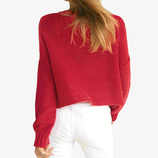 Woman wearing Aspen Crew Sweater in red cable knit with long sleeves and crew neckline