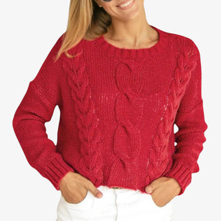 Woman wearing Aspen Crew Sweater in red cable knit with long sleeves and crew neckline