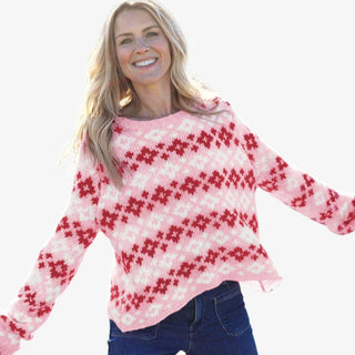 Woman wearing pink and red Fair Isle crew sweater with relaxed fit