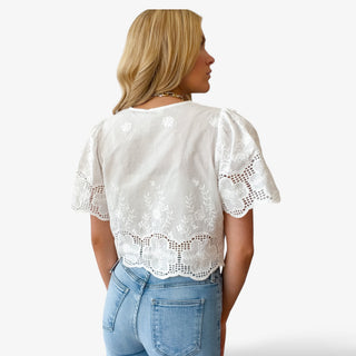 white lace crop top back view with embroidered lace detail and scalloped hem