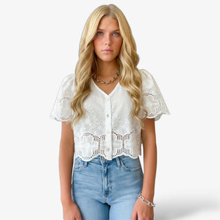 white lace crop top with floral embroidery and scalloped hem front view on blonde model
