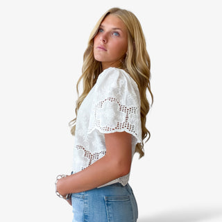 white lace crop top side view showing puff sleeves and lace trim detail