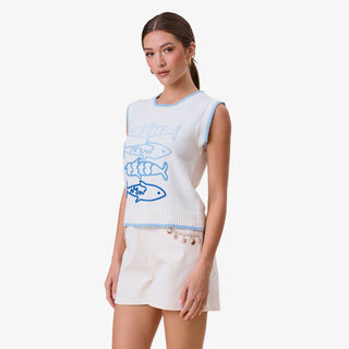 Sardine embroidered sweater vest in white with blue fish design styled with neutral shorts