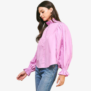 Pleated sleeve pink button down blouse ruffle neck front angled view