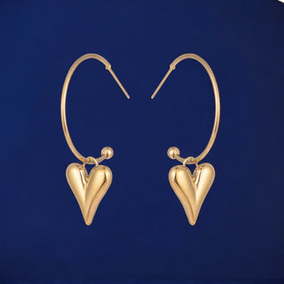 Jasmine gold heart hoop earrings with dangling heart charm in polished gold-tone metal