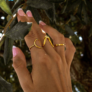 Gold wave ring worn on hand outdoors lifestyle view