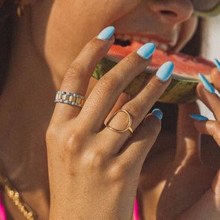 Gold wave ring on finger close-up side profile view