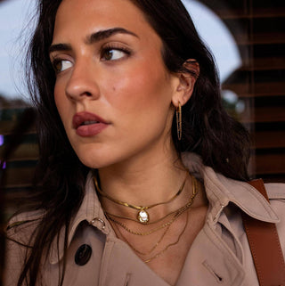 Gold pendant necklace with mother of pearl charm on model lifestyle view