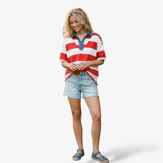 Americana stripe collared top styled with light wash denim shorts and blue sandals isolated full length front view