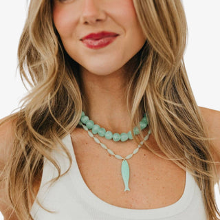 Aqua glass bead necklace with glossy rounded beads layered with aqua fish necklace 