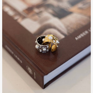 Gold wide band pearl statement ring with multi size pearls worn on hand