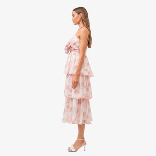 Pink floral tiered midi dress with bow detail bodice and ruffle layers styled with white heels