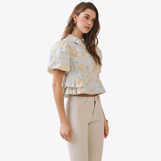 Blue floral peplum top with puff sleeves and collared button front detail styled with neutral high waisted pants