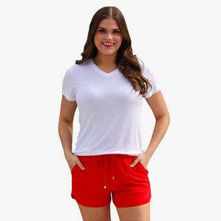 Red drawstring shorts with elastic waistband and pockets styled with patriotic star top front view