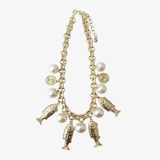 Gold coastal fish charm necklace with pearl accents and layered chain detail front view