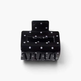 Black polka dot hair claw clip in small 2-inch size with white dots, front product view