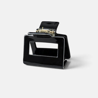 Small black square hair claw clip with glossy finish and open center cutout, 2-inch compact hair accessory front product view