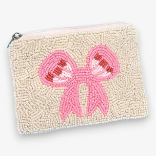 A beaded pouch with a central pink bow design, featuring a variety of bead colors on a light background.