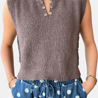Brown cropped knit sweater vest featuring textured knit fabric, cropped hem and natural button neckline, close-up detail view