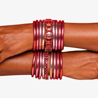 BudhaGirl Ombre Pink bangles on a person's wrist against a white background