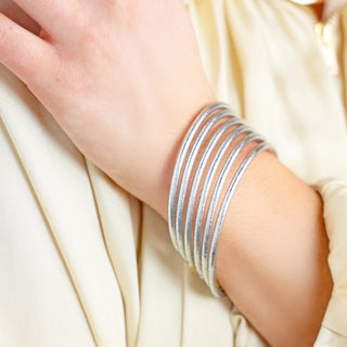 BuDhaGirl Lumine All Weather Bangles in Silver stacked on wrist showing slim 3mm profile