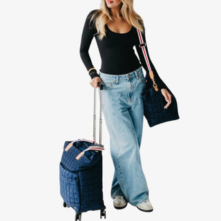 Jetsetter Quilted Rolling Tote in navy with quilted design, dual handles, and telescopic handle on wheels