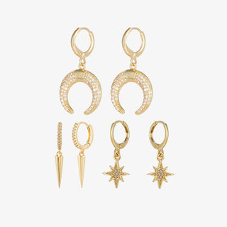 North Star gold earring set with pavé huggie hoops and interchangeable star, moon, and spike charms