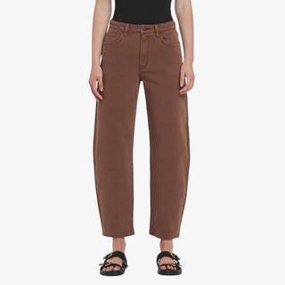 Woman wearing high rise brown barrel jeans with ankle length fit and relaxed leg