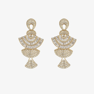 Gold crystal tiered statement dangle earrings with baguette and pave stones worn on model