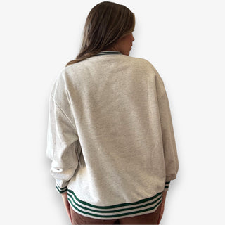 Queen of Sparkles grey Café Du Monde sweatshirt with green sport-stripe neckline and sequin graphic.