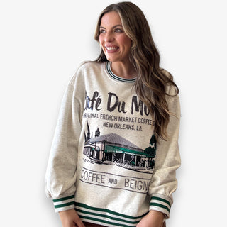 Queen of Sparkles grey Café Du Monde sweatshirt with green sport-stripe neckline and sequin graphic.