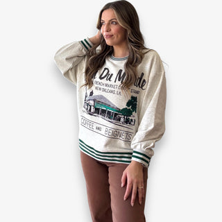 Queen of Sparkles grey Café Du Monde sweatshirt with green sport-stripe neckline and sequin graphic.