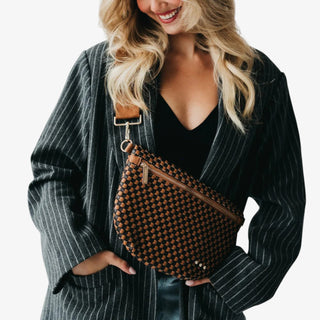 Woman wearing a Pretty Simple Westlyn Woven Bum Bag in checkered coffee and black with gold zipper, styled with a black top and pinstripe blazer.