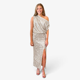 Champagne sequin side slit maxi skirt styled with a matching one shoulder top and metallic heels for formal events, full front view.