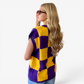 Back view of purple and gold checkered game day sweater top showing the bold checkerboard pattern and relaxed fit