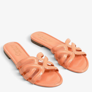 Pair of Circus NY by Sam Edelman Cat tangerine flat slide sandals with glossy cutout straps, angled view