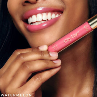 City Lips plumping lip gloss watermelon with gold cap for plumping shine on model
