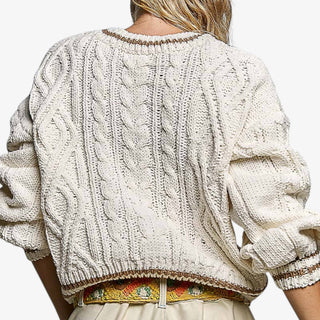 Cream cable knit sweater with brown contrast trim and cable knit texture, back view