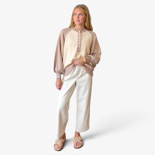 Taupe and cream color block Henley sweater styled with cream wide leg pants and neutral sandals, full outfit view.