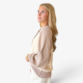 Taupe and cream color block Henley sweater with relaxed fit, balloon sleeve and ribbed hem, side view.