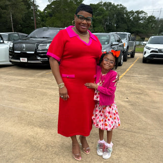 Customer wearing the red and hot pink colorblock sweater midi dress with collared neckline and gold button pocket accents